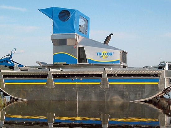 Dévasement de plan d'eau : bateau faucardeur